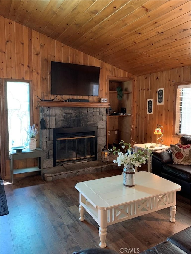 living room with vaulted ceiling, a fireplace, wood walls, wood ceiling, and dark hardwood / wood-style flooring