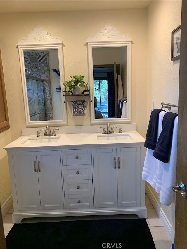 bathroom with tile patterned flooring and vanity