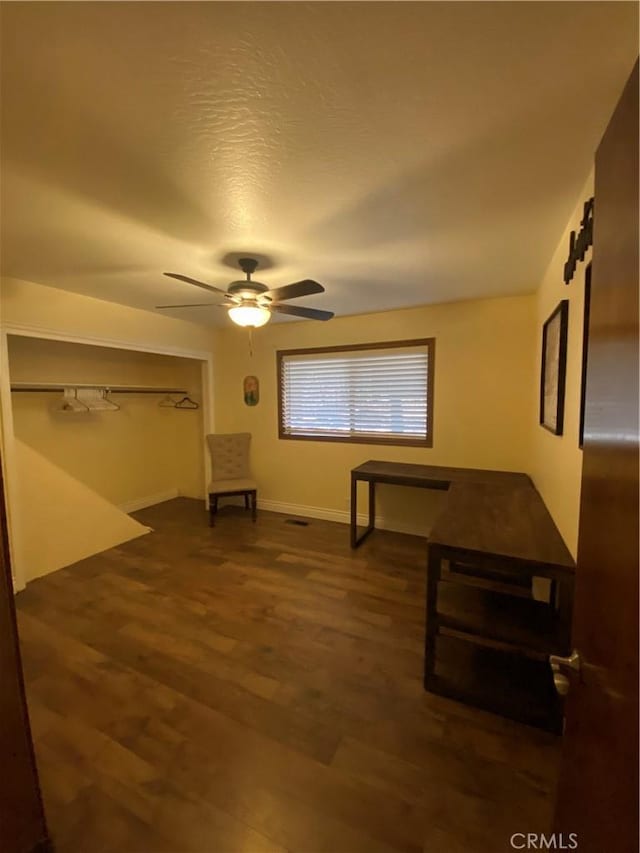 bedroom featuring a textured ceiling, a closet, dark hardwood / wood-style flooring, and ceiling fan