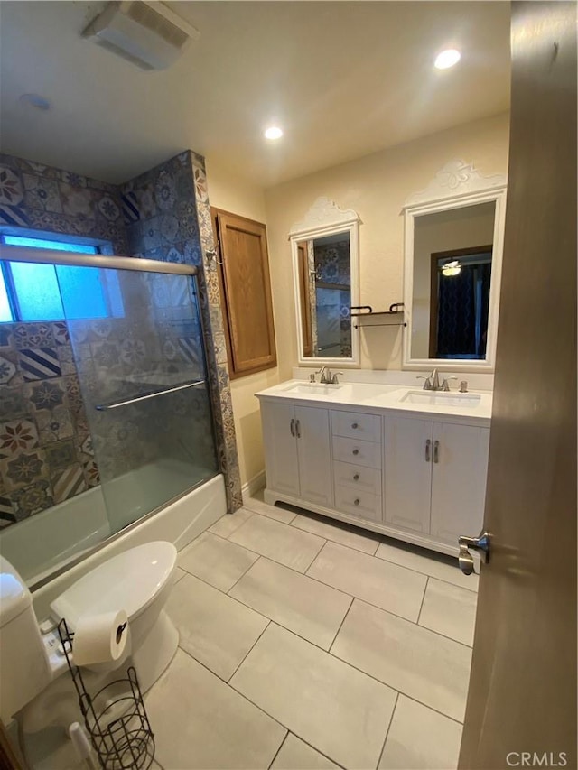 full bathroom featuring shower / bath combination with glass door, vanity, toilet, and tile patterned flooring