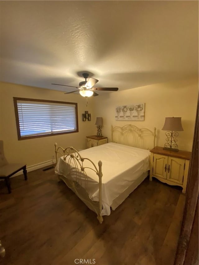 bedroom with ceiling fan and dark hardwood / wood-style flooring