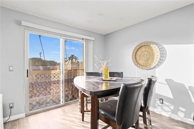 dining space with hardwood / wood-style flooring