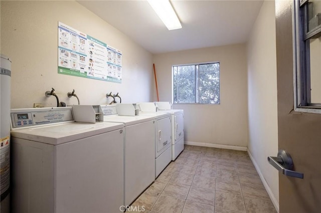 laundry room with washing machine and dryer and light tile patterned floors