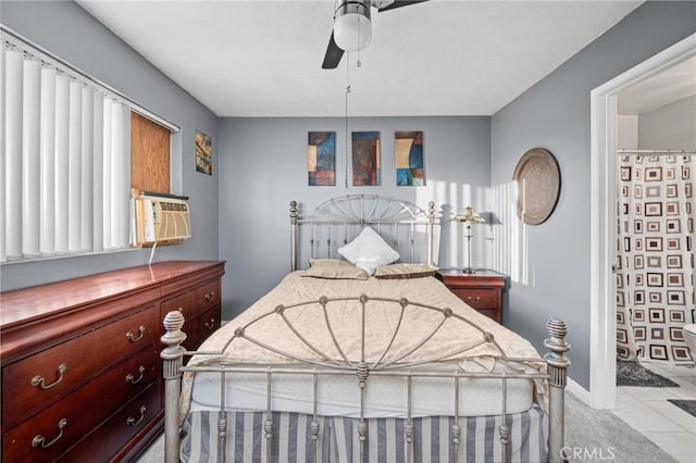 tiled bedroom with ceiling fan, cooling unit, and ensuite bathroom