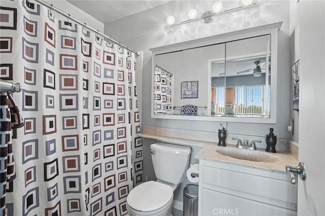 bathroom featuring vanity, ceiling fan, toilet, and curtained shower