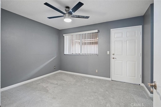 unfurnished room featuring light carpet and ceiling fan