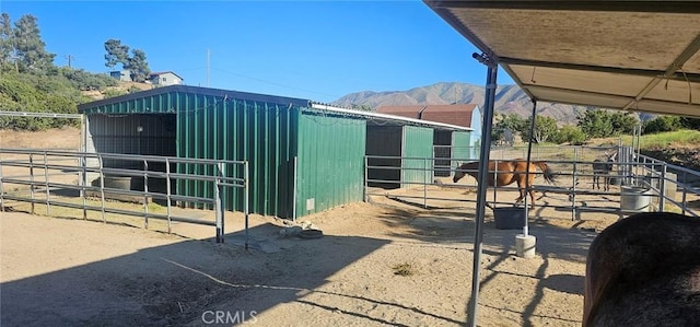 view of horse barn with a mountain view