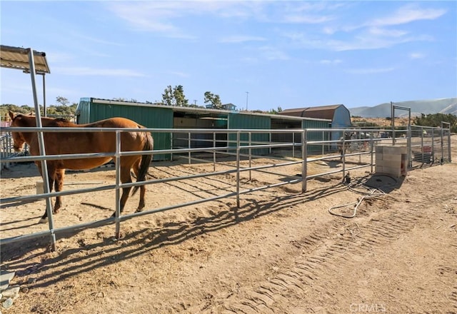 view of stable with a mountain view and a rural view