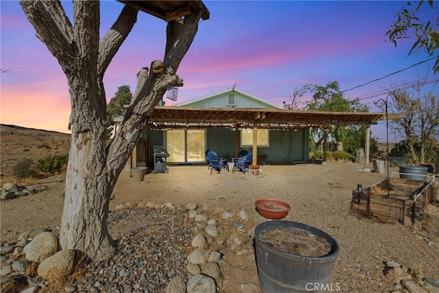 view of back house at dusk