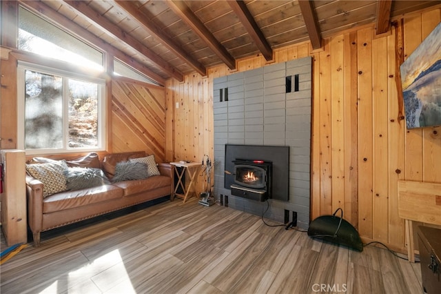 living room featuring vaulted ceiling with beams, wood walls, wooden ceiling, and wood finished floors