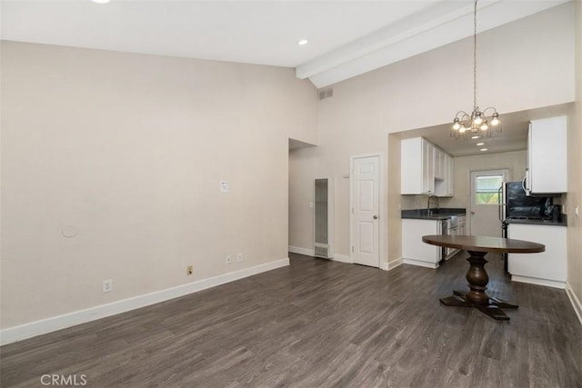 unfurnished living room with beam ceiling, dark wood-style flooring, visible vents, and baseboards