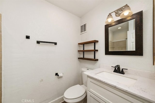 full bath featuring visible vents, vanity, toilet, and walk in shower