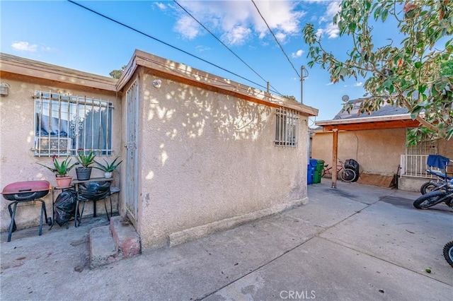 view of property exterior featuring a patio area