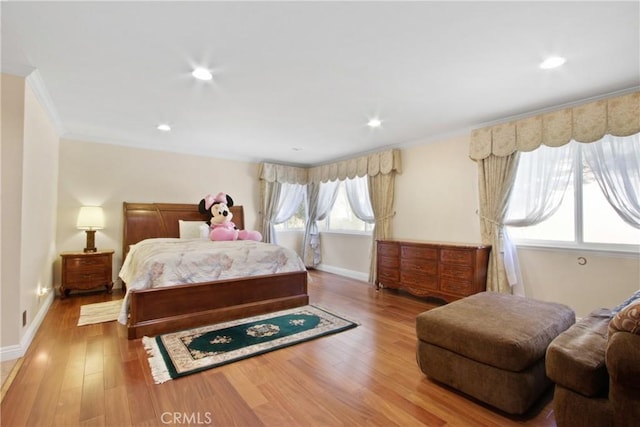 bedroom featuring ornamental molding and hardwood / wood-style flooring