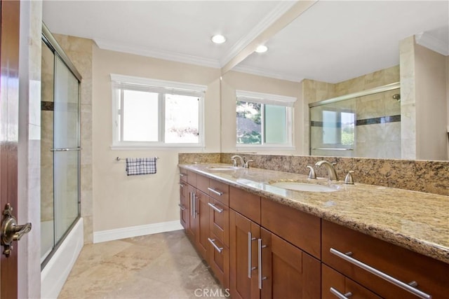 bathroom with shower / bath combination with glass door, vanity, and crown molding