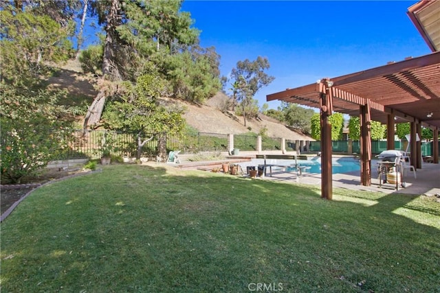 view of yard with a fenced in pool and a pergola