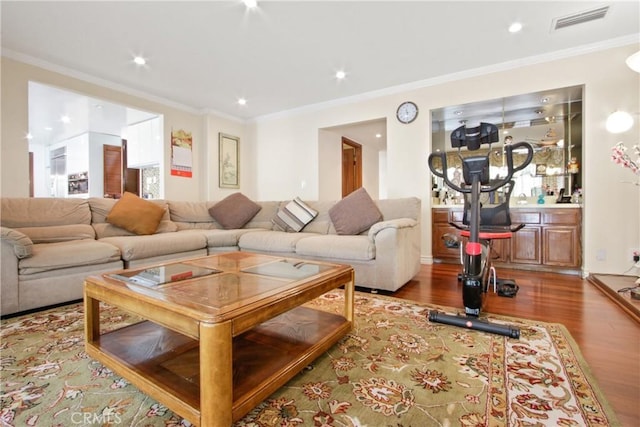 living room with ornamental molding and light hardwood / wood-style flooring