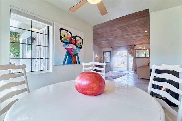 dining space with light tile patterned floors and wood ceiling