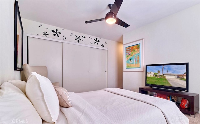 bedroom featuring ceiling fan, a closet, and carpet floors