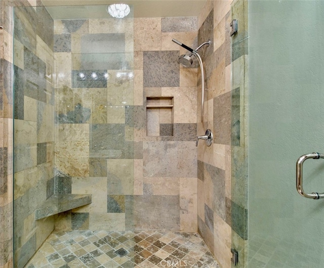 bathroom with a shower with door