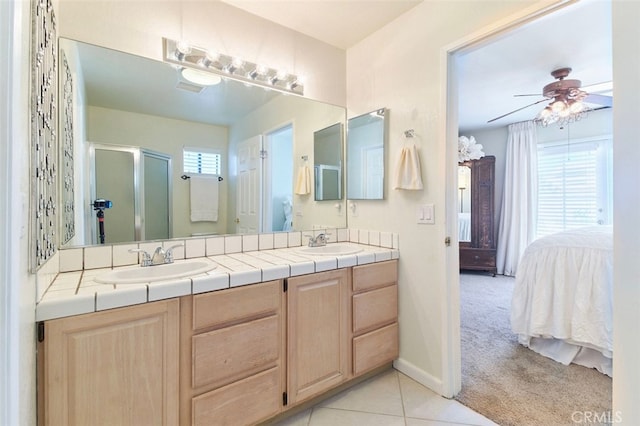 bathroom featuring tile patterned flooring, vanity, ceiling fan, and a healthy amount of sunlight