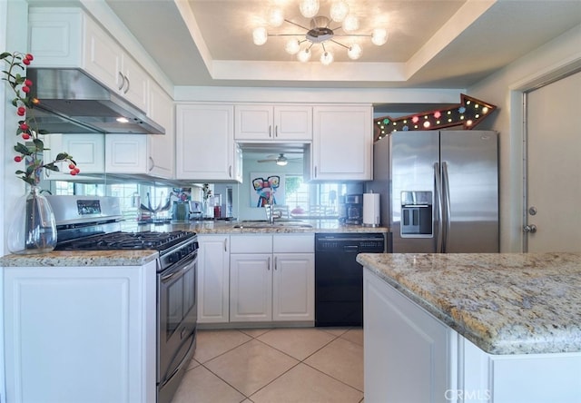 kitchen with white cabinets, stainless steel appliances, a raised ceiling, and sink