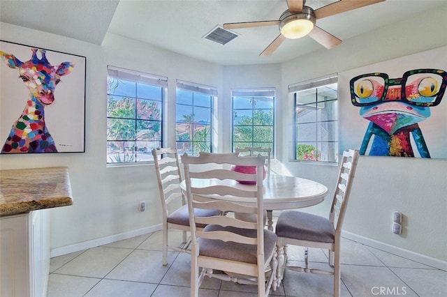 tiled dining space featuring ceiling fan