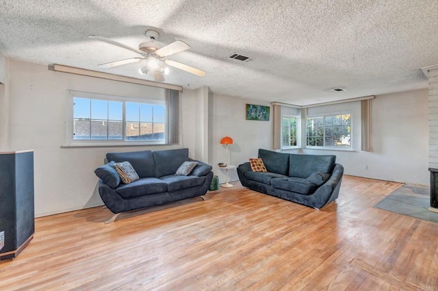 living room featuring a healthy amount of sunlight and a textured ceiling