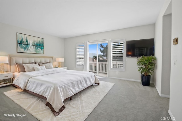 bedroom featuring light colored carpet and access to outside