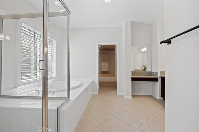 bathroom featuring tile patterned floors, a wealth of natural light, vanity, and plus walk in shower