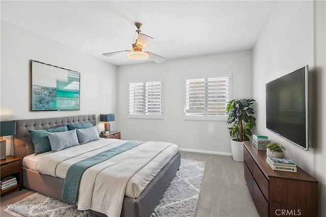 bedroom with ceiling fan and light carpet