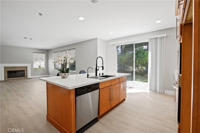 kitchen with plenty of natural light, sink, an island with sink, and appliances with stainless steel finishes