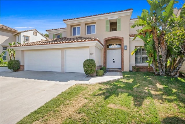 mediterranean / spanish-style home with a garage and a front lawn