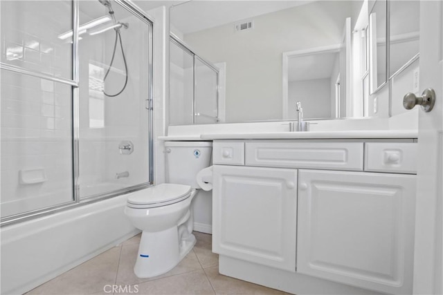 full bathroom featuring toilet, tile patterned flooring, vanity, and combined bath / shower with glass door