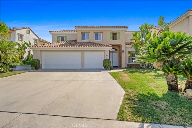 mediterranean / spanish home with a front yard and a garage