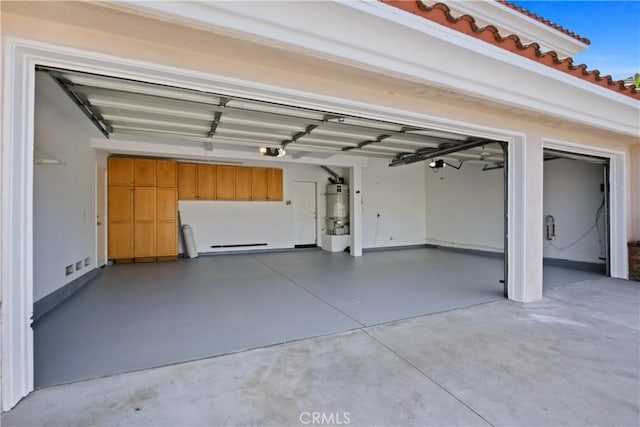 garage featuring secured water heater and a garage door opener