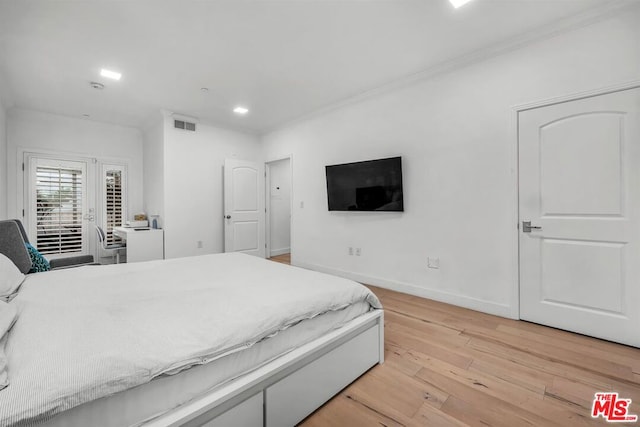 bedroom featuring light hardwood / wood-style floors and ornamental molding