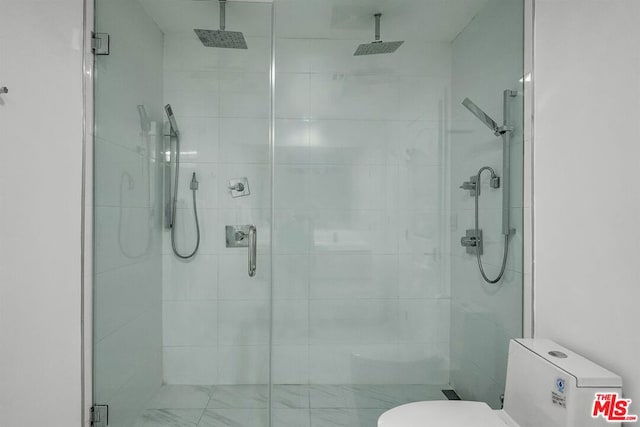 bathroom featuring toilet and walk in shower