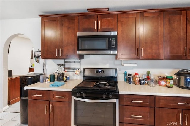 kitchen featuring light tile patterned flooring and stainless steel appliances