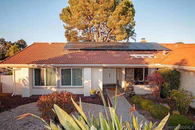 view of front of property with solar panels