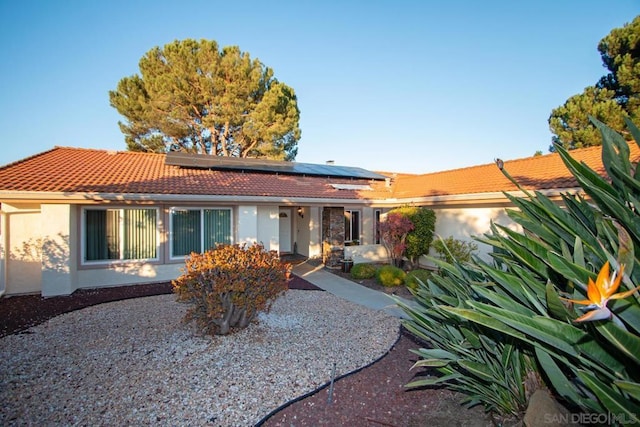 ranch-style home with solar panels