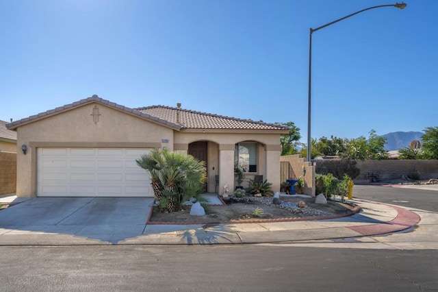 mediterranean / spanish-style home with a garage