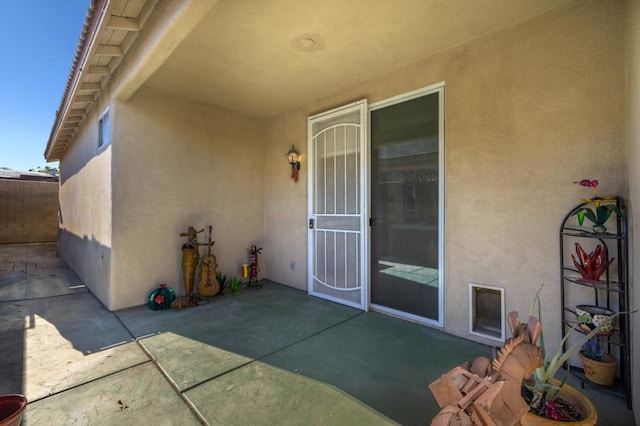 view of exterior entry featuring a patio area