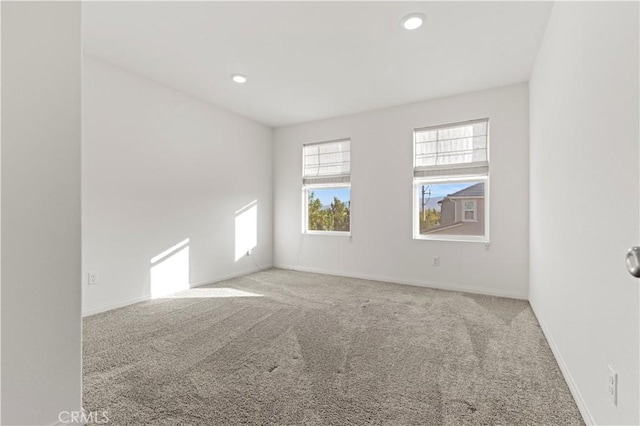 unfurnished room featuring light colored carpet