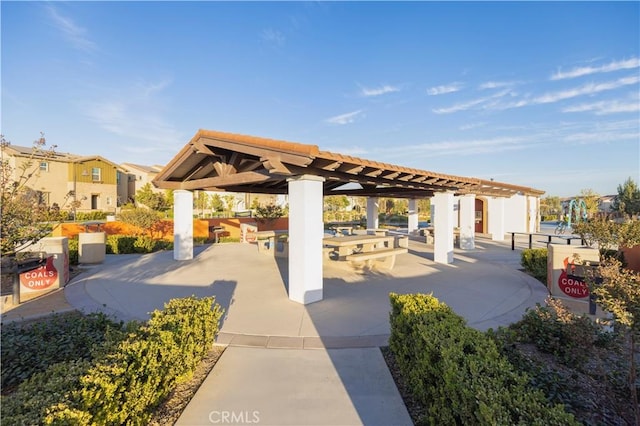 view of home's community with a pergola and a patio