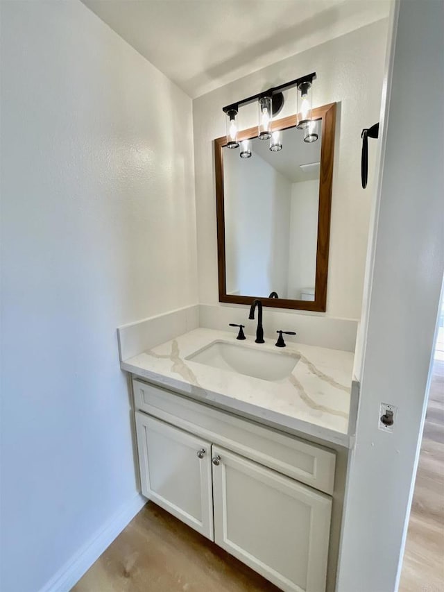 bathroom with hardwood / wood-style floors and vanity