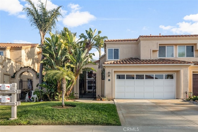 mediterranean / spanish-style house featuring a garage and a front yard