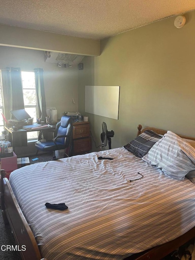 bedroom with a textured ceiling and carpet floors