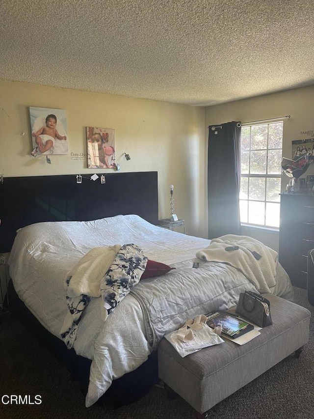 carpeted bedroom with a textured ceiling