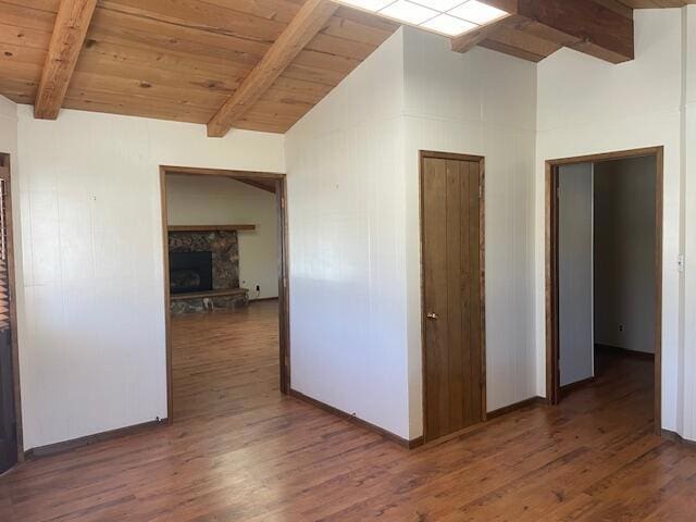 hall with lofted ceiling with beams, wooden ceiling, and dark wood-type flooring